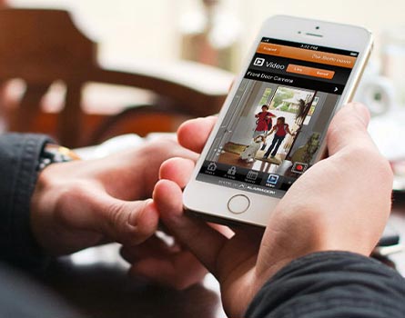 man monitoring home in his smartphone